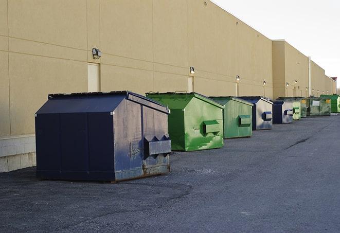 construction dumpsters on a worksite surrounded by caution tape in Alton